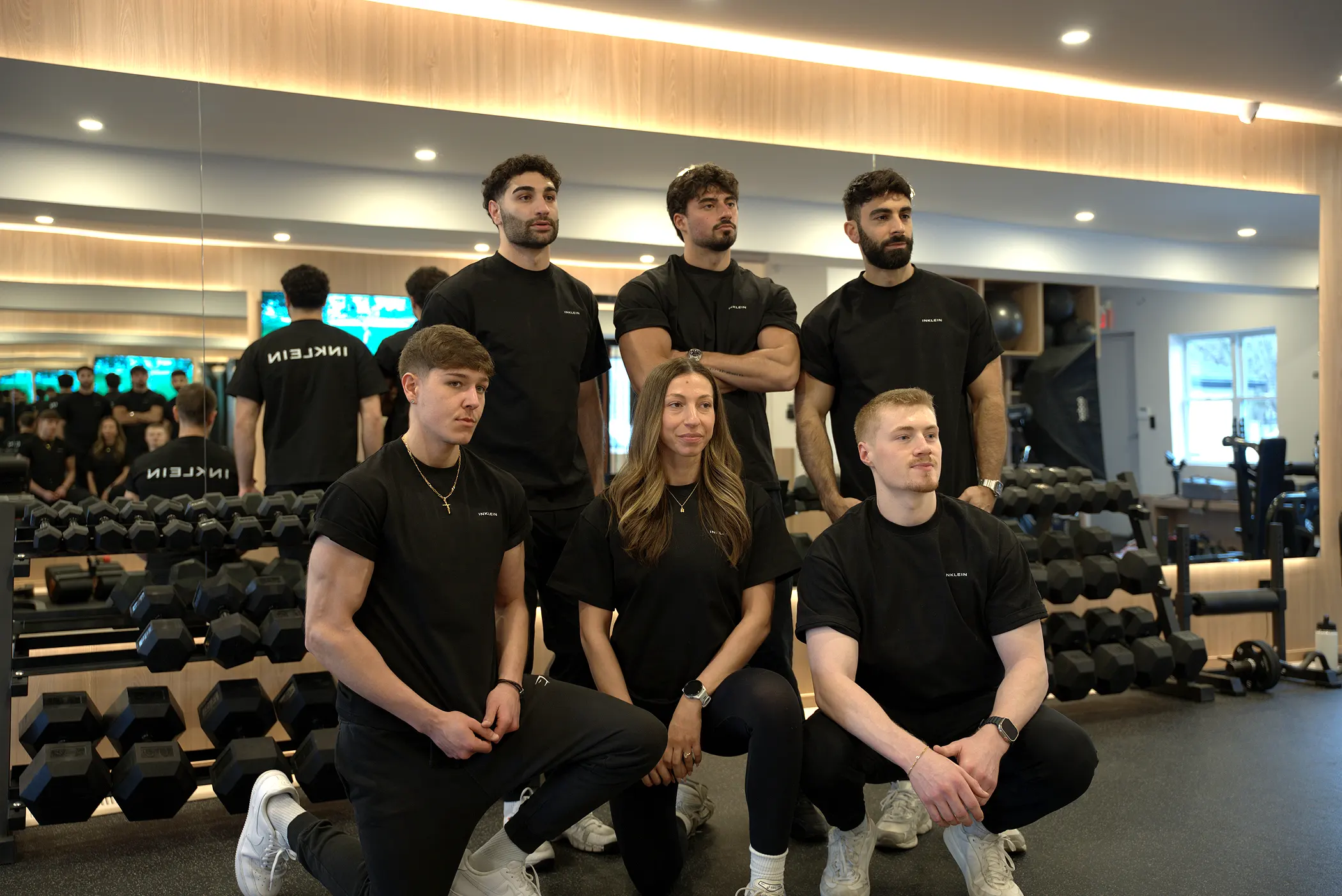 Personal trainer coaching a client through a dumbbell exercise