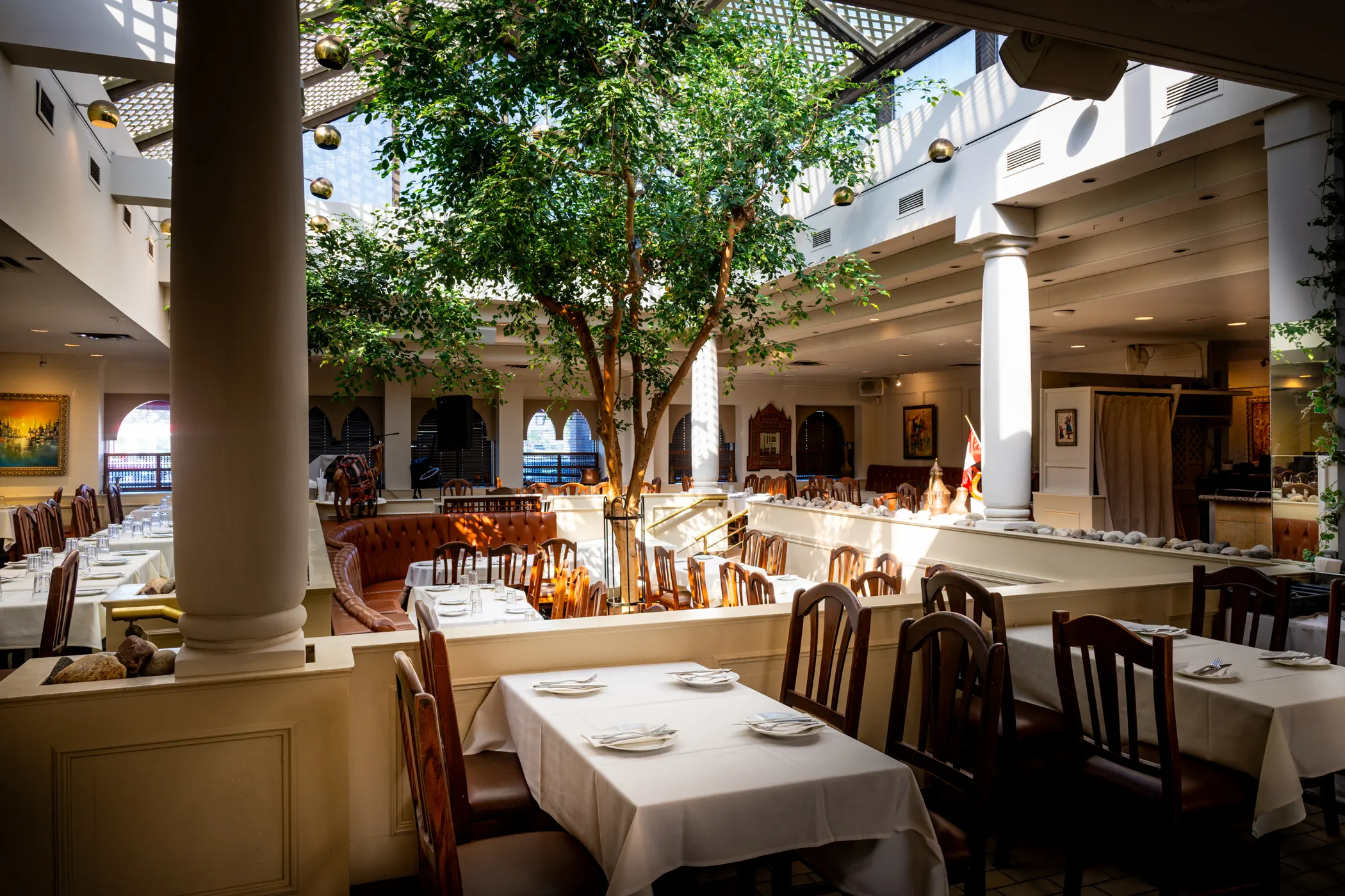 Warm light across a Mediterranean restaurant dining room