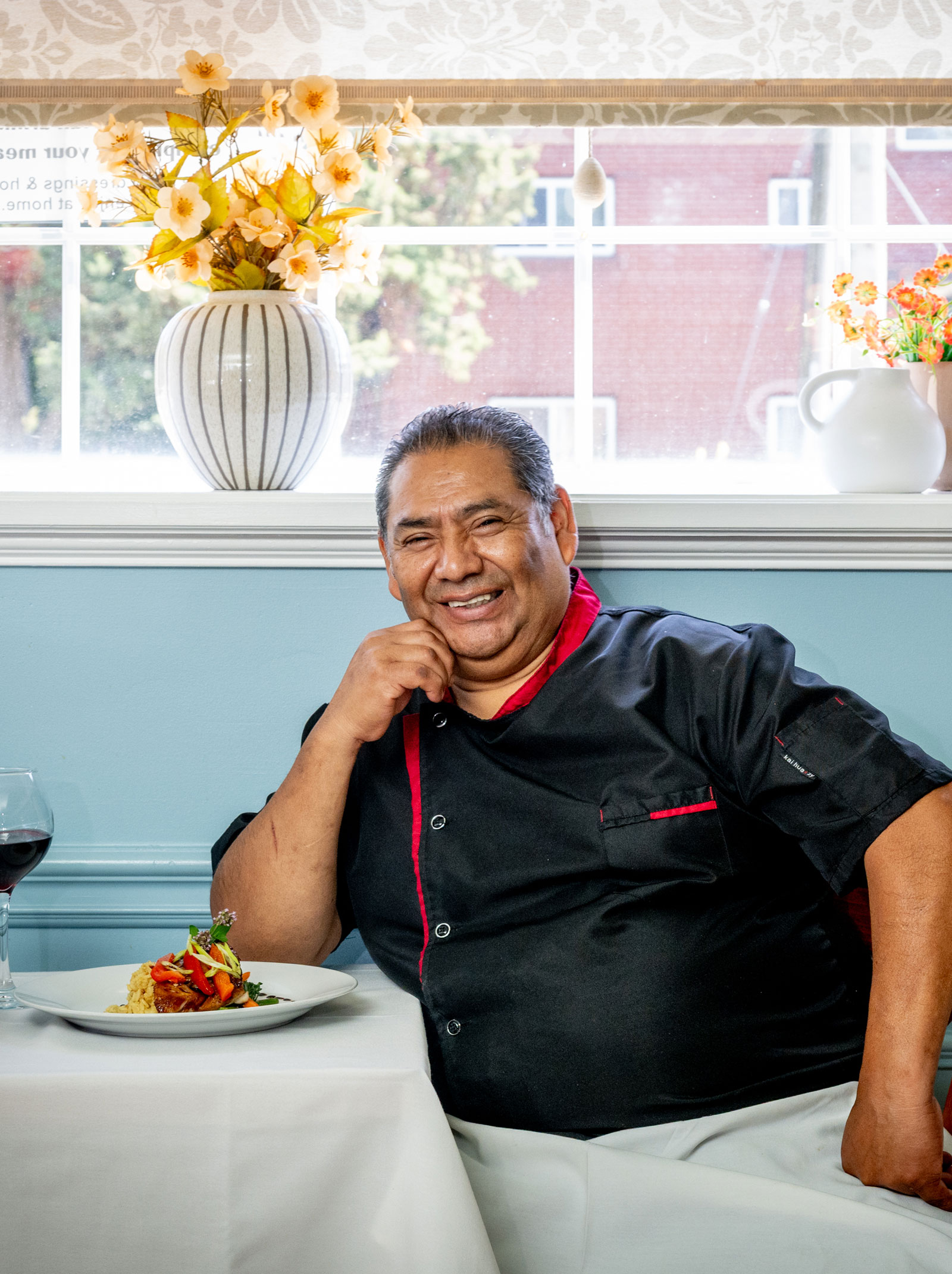Chef carefully plating a dish in a professional kitchen