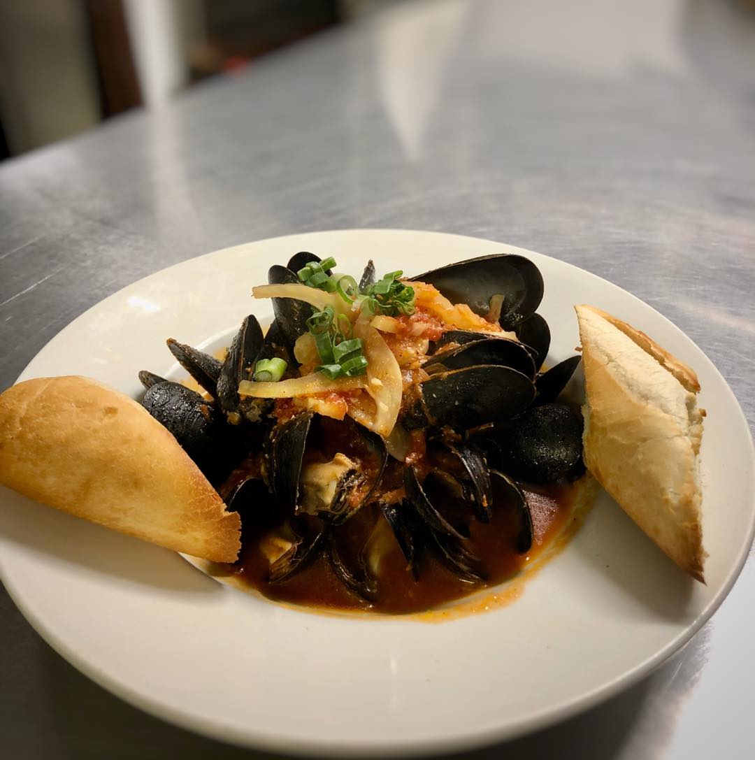 Mussels prepared with a white wine fennel tomato sauce.