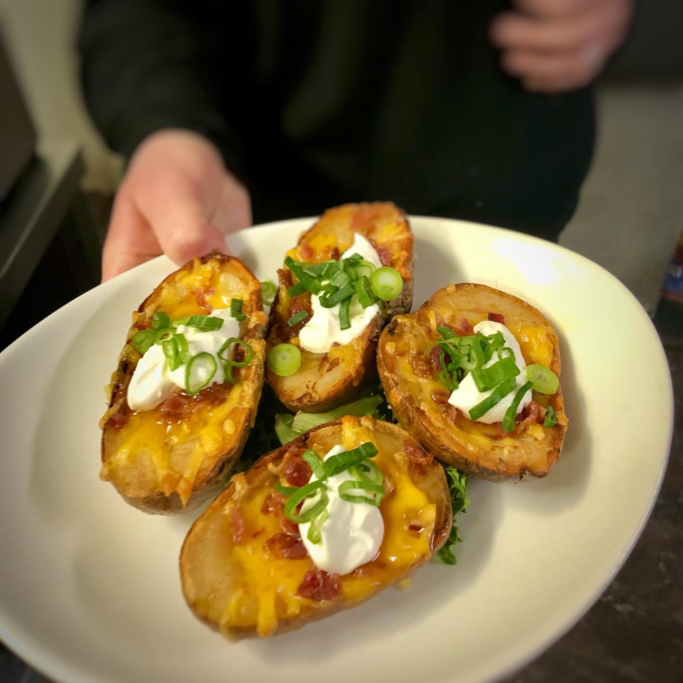Potato skins stuffed with cheddar and house smoked bacon.